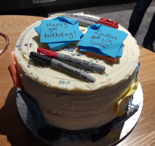 A six layer cake covered in post-it notes and sharpie pens made out of icing